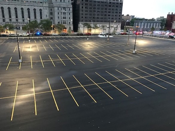 While she struggles to find a spot to park, a commodious and often empty lot sits outside Huston's apartment window. - PHOTO COURTESY KRISTEN HUSTON