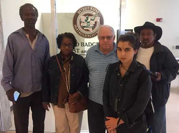 Moratorium Now! organizer Jerome Goldberg (center) and several other activists made their way through the Coleman A. Young Municipal Center Tuesday, urging Detroit city officials to save nearly 2,000 occupied properties from being sold at auction. - Violet Ikonomova