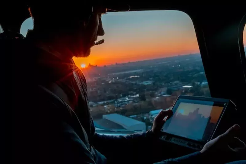 McGee guiding his extreme telephoto photography of downtown Detroit and the windmills far away in Ontario. - Courtesy Stephen McGee