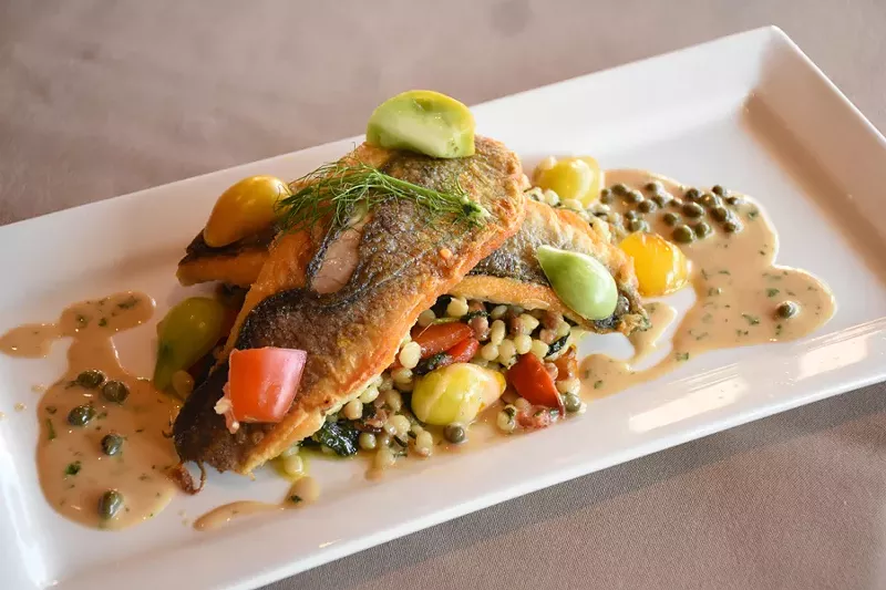 Assaggi’s bronzino can feature playful touches, such as the way the capers in this dish mimic the shape of the fregola sarda. - Rachel Timlin