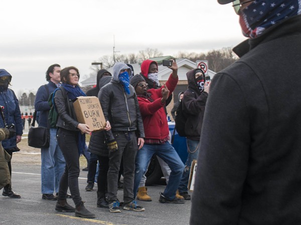 A protester flicks off members of the Traditionalist Worker Party, a neo-Nazi group. - TOM PERKINS