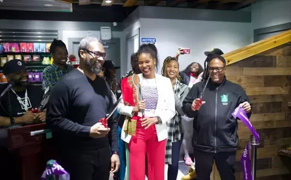 The grand opening of High Profile Detroit included Council President Pro Tem James Tate (left) and co-owner Najanava Harvey-Quinn (center).