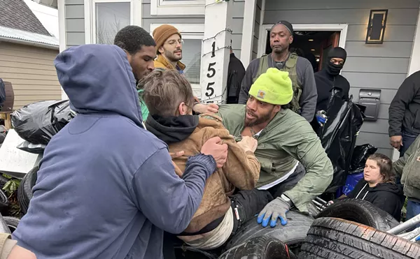 Bailiffs and movers forcibly remove protesters who were protecting Taura Brown from being evicted in Detroit.