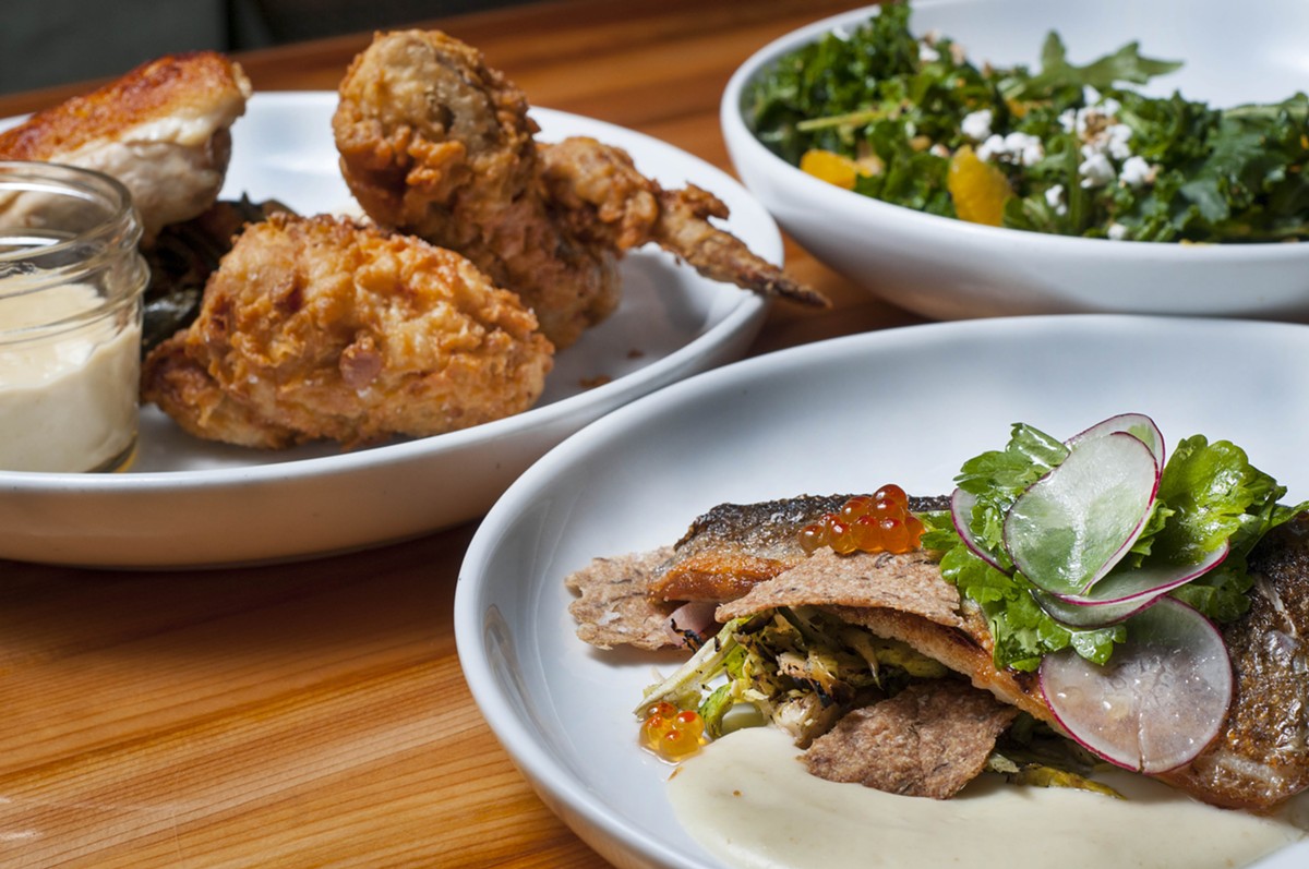 Clockwise, from left: 1/2 Chicken 2 Ways, Loup de Mer, and Kale and Grain salad.