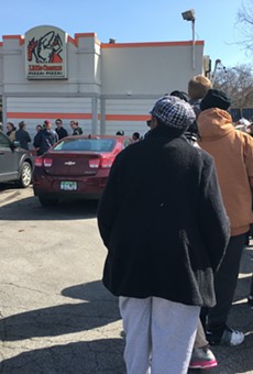 A line snakes around the parking lot of the Little Caesars in Ferndale ahead of Monday's free lunch combo promo.