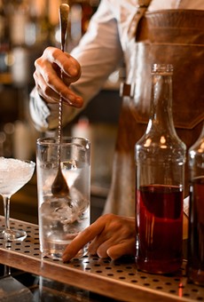 A bartender makes cocktails.