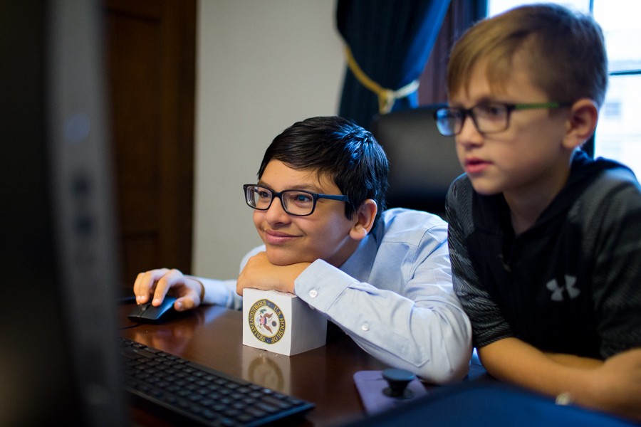 Tlaib’s son, Adam, reads the day’s news on his mother’s newly set up computer in her office. - ERIK PAUL HOWARD
