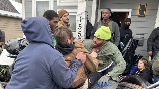 Bailiffs and movers forcibly remove protesters who were protecting Taura Brown from being evicted in Detroit.