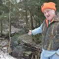 John McLane points to a gentle stream that Nestlé claims flows at 2,058 gallons per minute. John McLane points to a gentle stream that Nestlé claims flows at 2,058 gallons per minute.
