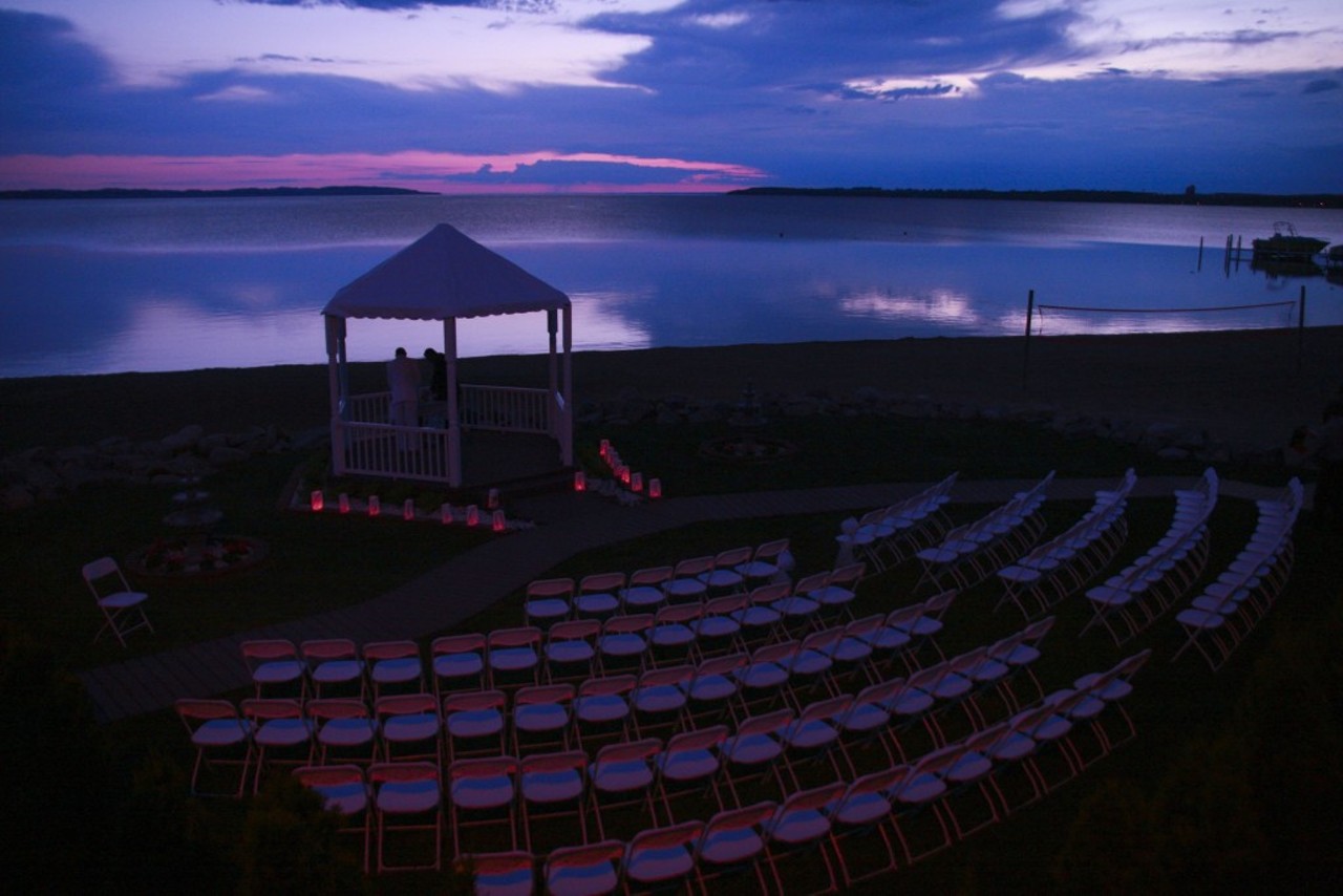 Park Shore Resort: An outdoor wedding venue, Park Shore Resort offers a lakefront view from its wedding gazebo. After the ceremony, move to the outdoor reception deck and check out the cuisine of local vendors. Situated in Traverse City, this wedding getaway will provide guests with the rich culture and activities of the city. Located at 1401 US 31, North Traverse City. Photo via www.parkshoreresort.com.