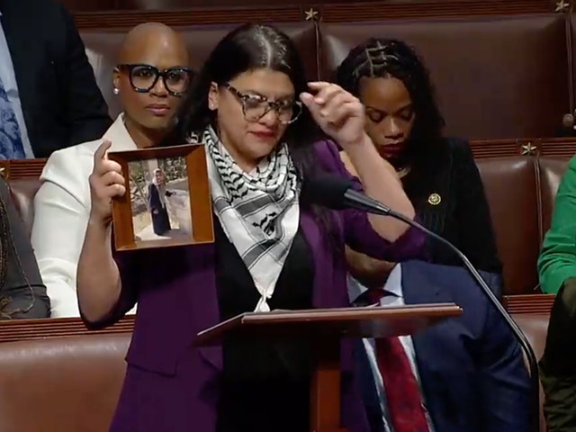 U.S. Rep. Rashida Tlaib holds up a photo of her Palestinian grandmother on the House floor.