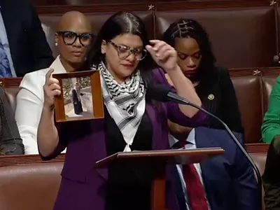 U.S. Rep. Rashida Tlaib holds up a photo of her Palestinian grandmother on the House floor.