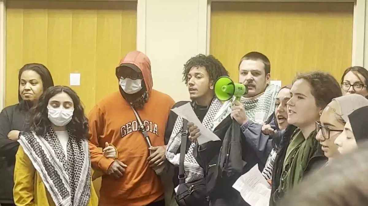 Image: A still from a video showing students and staff at Wayne State University who were removed after demanding the school divest from Israel.