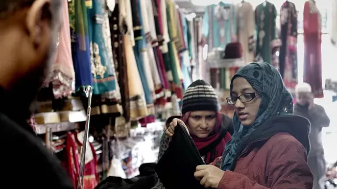 A 15-year-old girl buys her first abaya at Caniff Gift & Variety.